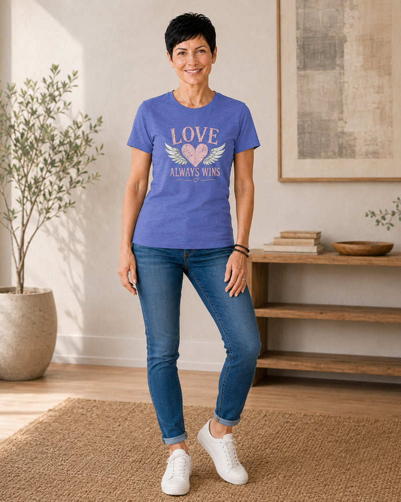 Front view of the Lolly Dagger Love Always Wins tee in Heather True Royal, Winged Heart design.